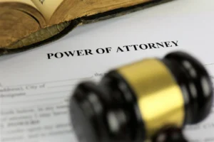A power of attorney agreement with a gavel resting on top.