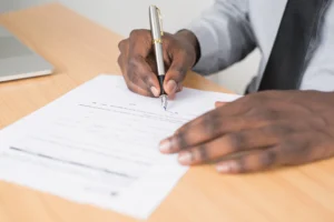 A person signing paperwork.