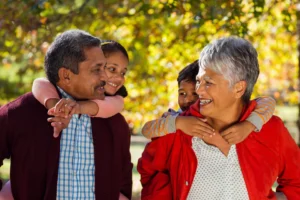 Grandparents giving their grandkids piggyback rides.