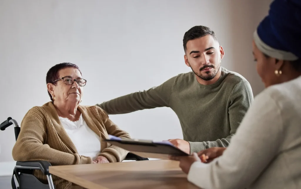 Elderly woman and her grandson meeting with an attorney.